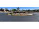 Landscaped traffic circle with colorful flowers and ornamental shrubs enhances neighborhood aesthetics and traffic flow at 4562 White Cap Mill St, Las Vegas, NV 89147