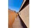 Side yard features concrete and stucco wall at 4562 White Cap Mill St, Las Vegas, NV 89147