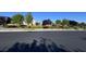 Neighborhood street view showcases a well-maintained grassy median with mature landscaping and trees at 4562 White Cap Mill St, Las Vegas, NV 89147
