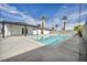 Inviting pool in the backyard is surrounded by desert landscaping and a covered patio for relaxing at 4629 Lilliput Ln, Las Vegas, NV 89102