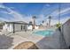 Bright backyard showcasing a refreshing pool with white exterior and desert landscaping under a clear blue sky at 4629 Lilliput Ln, Las Vegas, NV 89102