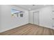 Bedroom showcasing luxury vinyl plank flooring, white walls, and a double-door closet at 4629 Lilliput Ln, Las Vegas, NV 89102