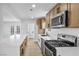 Modern kitchen with white countertops, wood cabinets, and stainless steel appliances, offering a sleek and functional design at 4629 Lilliput Ln, Las Vegas, NV 89102