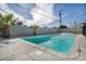 Sparkling pool with surrounding concrete patio and desert landscaping offers a refreshing outdoor oasis at 4629 Lilliput Ln, Las Vegas, NV 89102