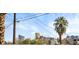 City skyline featuring well-known buildings, seen above the block wall and palm tree at 4629 Lilliput Ln, Las Vegas, NV 89102