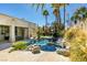 Enjoy the private backyard pool with rock waterfall feature, patio, and mature landscaping at 4635 Bird View Ct, Las Vegas, NV 89129