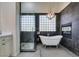 Elegant bathroom featuring a freestanding tub, walk-in shower, and modern fixtures at 4635 Bird View Ct, Las Vegas, NV 89129