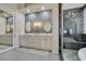 Luxurious bathroom with double vanity, a modern walk-in shower, and elegant lighting at 4635 Bird View Ct, Las Vegas, NV 89129