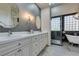 Bright bathroom with double sinks, quartz countertop, and elegant fixtures at 4635 Bird View Ct, Las Vegas, NV 89129