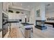 Modern kitchen features white cabinetry, granite counters, a center island, and views into the living space at 4635 Bird View Ct, Las Vegas, NV 89129