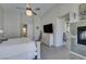 Bright main bedroom with neutral tones, decorative fireplace, and hardwood flooring at 4635 Bird View Ct, Las Vegas, NV 89129