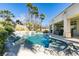 This beautiful backyard pool features a rock waterfall feature and mature palm trees at 4635 Bird View Ct, Las Vegas, NV 89129