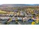 High-angle view of homes in a residential area adjacent to a golf course, showcasing desert vegetation and mountain scenery at 4718 Atlantico St, Las Vegas, NV 89135