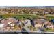 Stunning aerial view of a home near a golf course in a suburban neighborhood with city views in the distance at 4718 Atlantico St, Las Vegas, NV 89135