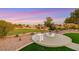 Backyard featuring manicured grass, a desert landscape, and sunset views at 4718 Atlantico St, Las Vegas, NV 89135