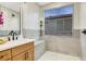 Bathroom featuring a shower with a seat, a wooden vanity, and modern fixtures at 4718 Atlantico St, Las Vegas, NV 89135