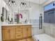 Modern bathroom featuring double vanity, a glass shower, and a decorative flower accent at 4718 Atlantico St, Las Vegas, NV 89135