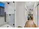 View through the hall into the modern bathroom, featuring a frameless glass shower at 4718 Atlantico St, Las Vegas, NV 89135