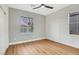 Empty bedroom featuring wood floors, a ceiling fan, and large windows at 4718 Atlantico St, Las Vegas, NV 89135