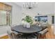 Bright dining area featuring a modern chandelier, table with leather chairs, and views into the living area at 4718 Atlantico St, Las Vegas, NV 89135