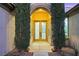 Elegant front door with decorative glass and tall, slender trees on either side at 4718 Atlantico St, Las Vegas, NV 89135