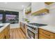 Gourmet kitchen featuring stainless steel appliances, custom wood cabinets, and a large window at 4718 Atlantico St, Las Vegas, NV 89135