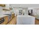 Bright kitchen featuring a large island with quartz countertop, stainless steel appliances, and wood accents at 4718 Atlantico St, Las Vegas, NV 89135