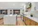 Bright kitchen featuring a large island with quartz countertop, stainless steel appliances, and wood accents at 4718 Atlantico St, Las Vegas, NV 89135