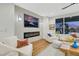 Comfortable living room featuring a modern electric fireplace and large windows at 4718 Atlantico St, Las Vegas, NV 89135