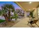 Covered patio showcasing desert landscaping with palm trees and an outdoor seating area at 4718 Atlantico St, Las Vegas, NV 89135