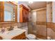 Cozy bathroom featuring a shower, a sink, and a wooden medicine cabinet at 4871 Reiter Ave, Las Vegas, NV 89108