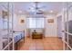 Well-lit bedroom with tile floors, a ceiling fan, and french doors at 4871 Reiter Ave, Las Vegas, NV 89108