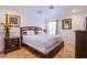 Cozy bedroom showcasing a comfortable bed, dresser, and natural light from the window at 4871 Reiter Ave, Las Vegas, NV 89108