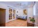 Bright bedroom with tile flooring, ceiling fan, and french doors leading to the kitchen at 4871 Reiter Ave, Las Vegas, NV 89108