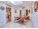 Bright dining room with a round table, four chairs, and a skylight for natural illumination at 4871 Reiter Ave, Las Vegas, NV 89108