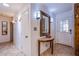 Inviting entryway featuring tile flooring, decorative mirror, and modern lighting fixtures at 4871 Reiter Ave, Las Vegas, NV 89108