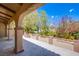 Covered front porch showing landscaping with mature trees and decorative border fence at 4871 Reiter Ave, Las Vegas, NV 89108