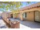 Inviting front porch with decorative columns, tiled roof and desert landscape at 4871 Reiter Ave, Las Vegas, NV 89108