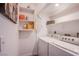 Bright laundry room with washer, dryer and shelving at 4871 Reiter Ave, Las Vegas, NV 89108