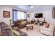 Comfortable living room with tile flooring, plush seating, and natural light from the window at 4871 Reiter Ave, Las Vegas, NV 89108