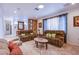 Inviting living room with tile flooring, plush sofas, and decorative wall accents at 4871 Reiter Ave, Las Vegas, NV 89108