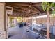 Covered outdoor patio with picnic table, barbecue, and lush greenery at 4871 Reiter Ave, Las Vegas, NV 89108