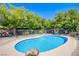 Kidney-shaped pool surrounded by a brick patio and white metal fence at 4871 Reiter Ave, Las Vegas, NV 89108