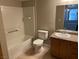 Bright bathroom with a bathtub, white toilet, tile floors, and a vanity with a granite countertop at 5055 W Hacienda Ave # 1028, Las Vegas, NV 89118