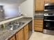 Kitchen featuring granite countertops, stainless steel appliances, and modern cabinetry offers a contemporary cooking space at 5055 W Hacienda Ave # 1028, Las Vegas, NV 89118