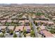 Extensive aerial view of a residential area showcasing numerous homes with well-maintained yards and community landscaping at 5271 Villa Vecchio Ct, Las Vegas, NV 89141