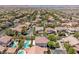 Expansive aerial view of a residential neighborhood with lush landscaping and beautiful homes, some featuring private pools at 5271 Villa Vecchio Ct, Las Vegas, NV 89141