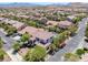 Aerial view of a home with a backyard pool, surrounded by lush landscaping and residential streets at 5271 Villa Vecchio Ct, Las Vegas, NV 89141