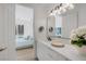 Modern bathroom featuring dual vanity with quartz countertop and view of a pool at 5271 Villa Vecchio Ct, Las Vegas, NV 89141