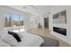 Bright bedroom with a modern fireplace and sliding glass doors to the balcony at 5271 Villa Vecchio Ct, Las Vegas, NV 89141